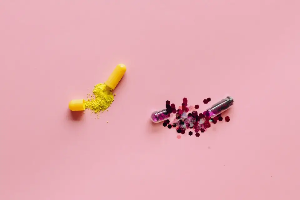 A soft chew, a powder packet, and a capsule supplement laid side by side on a table