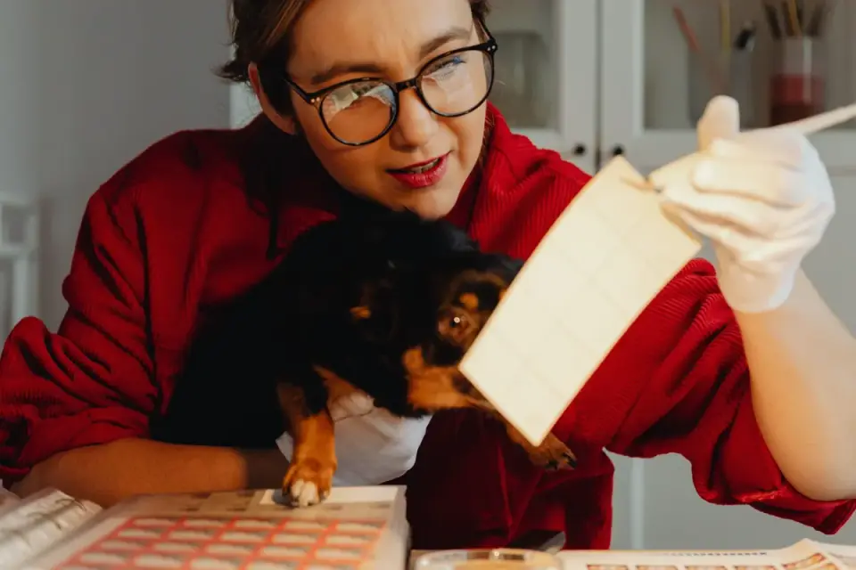 A veterinarian comparing two supplement labels side by side with a small dog on the exam table