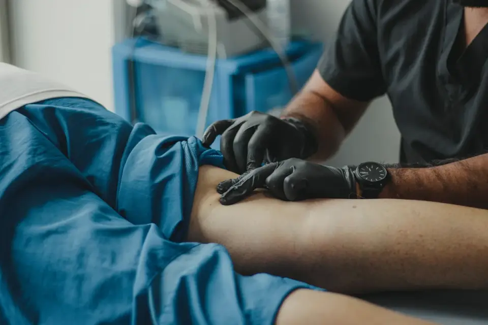 A veterinarian gently palpating a dog&#x27;s abdomen during a checkup
