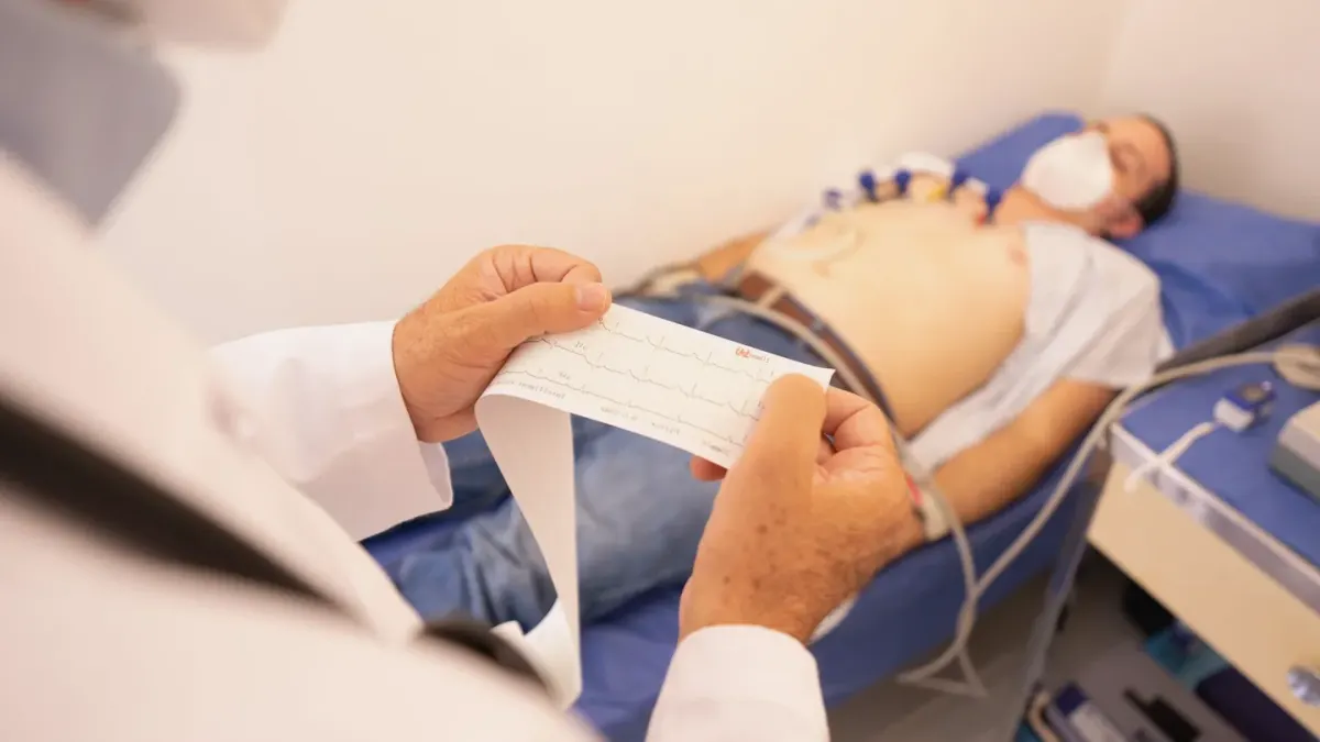 A veterinarian gently palpating a golden retriever's abdomen during a wellness exam