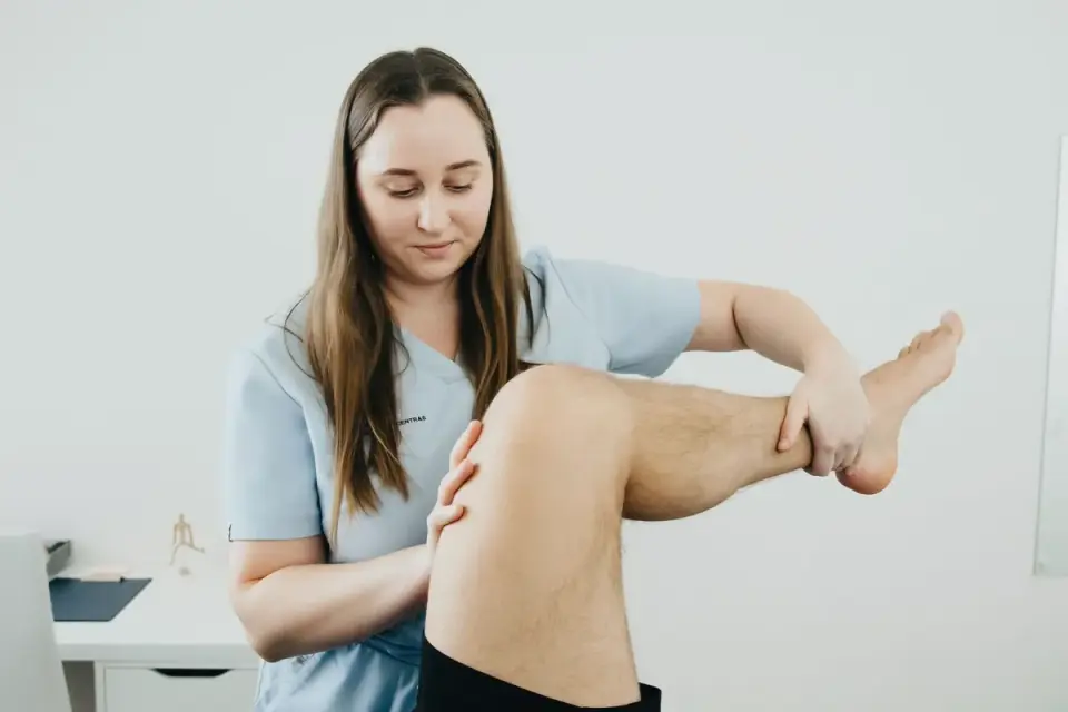 A veterinarian gently palpating a senior dog&#x27;s hip during a mobility exam
