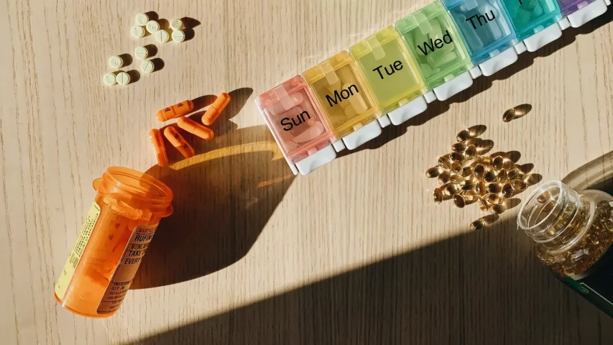 Bottles of dog chew supplements next to an open subscription delivery box on a kitchen counter