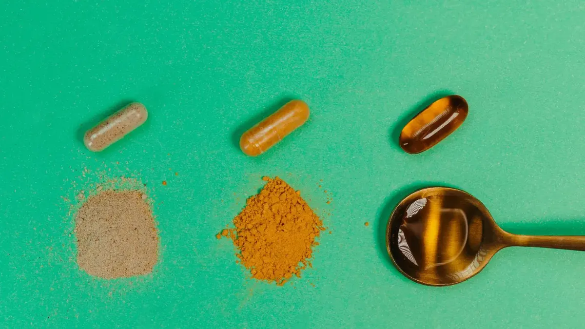 Two dog supplement containers, one powder and one freeze-dried, next to measuring scoops